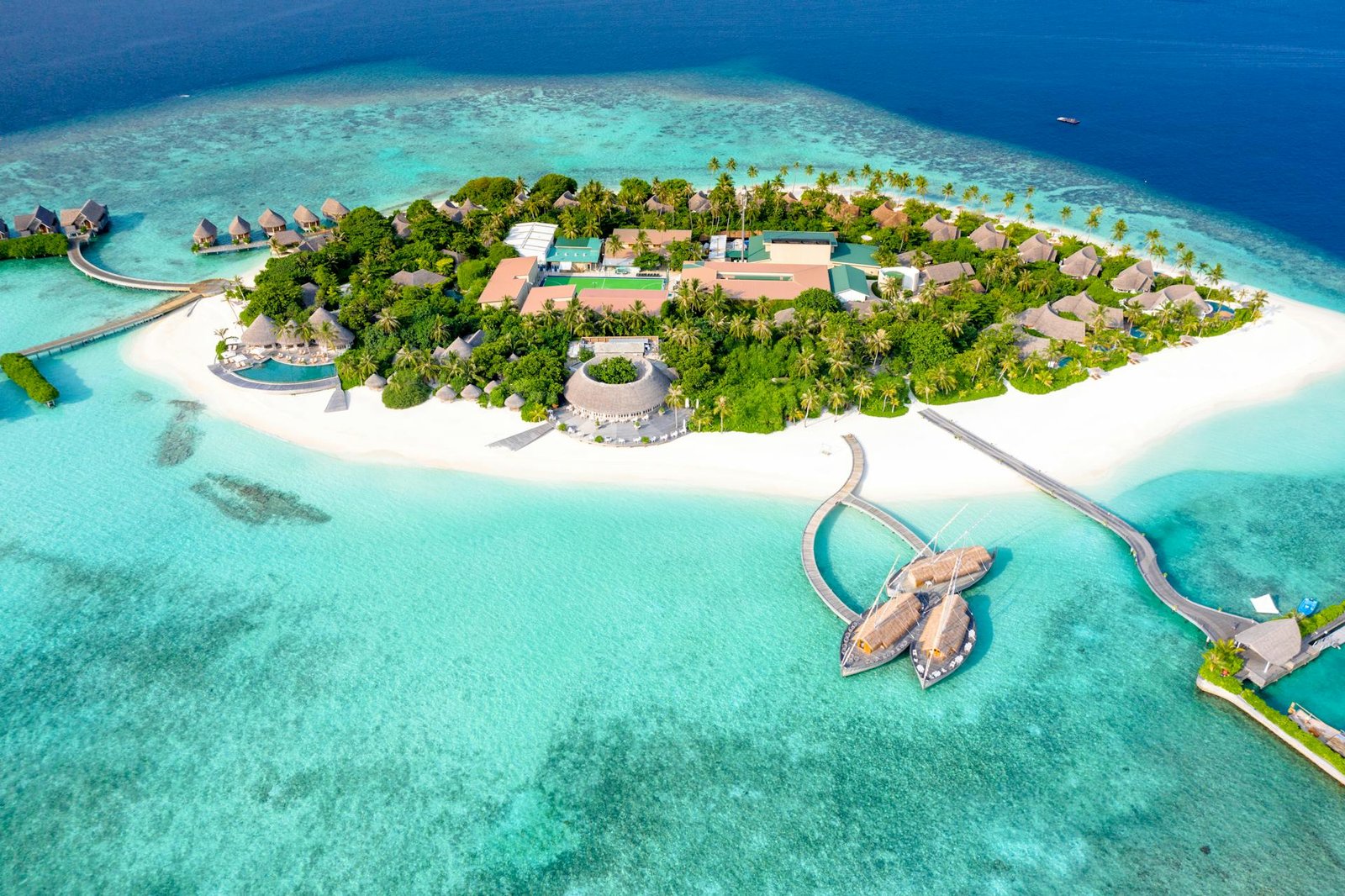 Maldives private island resort with overwater villas – luxury escape curated by Chaya Voyages.