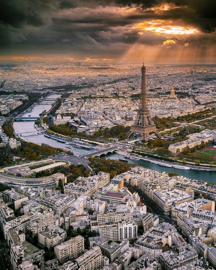 Exclusive luxury tours and events in Paris with panoramic view of the Eiffel Tower, Seine River, and city skyline by Chaya Voyages.