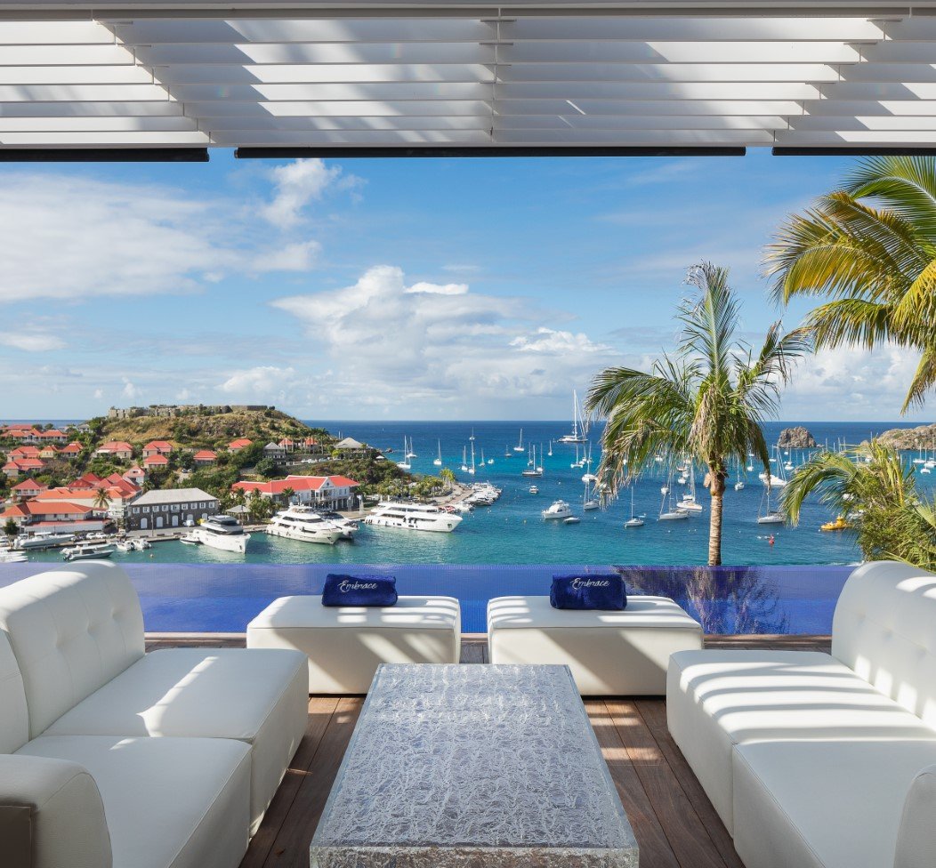 Exclusive luxury tours and events in the Caribbean with infinity pool, luxury villas, and panoramic yacht harbor views by Chaya Voyages.